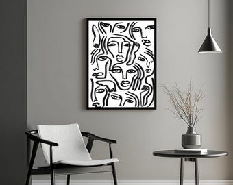 May include: Black and white abstract art print featuring multiple stylized faces. The artwork is framed in a black border and hangs on a gray wall. A modern black chair and side table with a vase are in the foreground.