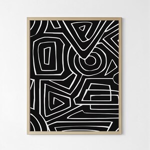 May include: Abstract art print with a black background and white geometric shapes. The design includes lines, triangles, and circles, creating a modern pattern. The artwork is framed in a gold-coloured frame.