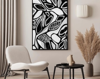 May include: Abstract black and white art print in a black frame. The artwork features organic shapes and patterns. The room also includes a beige chair, a small black table, a vase with dried plants, and a decorative wall sconce.
