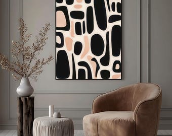 May include: Abstract art print featuring black and blush-colored organic shapes on an off-white background, framed in black. The artwork hangs above a brown armchair and a small round ottoman. A vase with dried branches sits on a wooden stand.