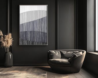 May include: An abstract wall art print with a silver frame. The artwork features horizontal bands of white, gray, and navy blue with vertical white lines. The room has a dark gray color scheme, a gray armchair, and a vase with dried plants.
