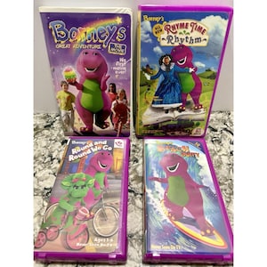 May include: Four Barney VHS tapes. Titles include "Barney's Great Adventure: The Movie", "Rhyme Time Rhythm", "Round and Round We Go", and "Beach Party". Each tape features Barney the dinosaur in various scenes, with text on the covers.