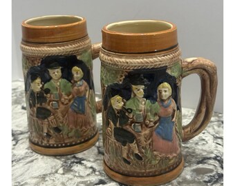 2 Vintage Japanese Ceramic Beer Steins Embossed People Castle 5.5" Tall