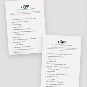 May include: Two white rectangular wedding game cards titled i Spy WITH MY LITTLE CAMERA in black and blue text. The cards feature a checklist of photography prompts including group photo, bride and groom laughing, cute couple, and silly selfie.