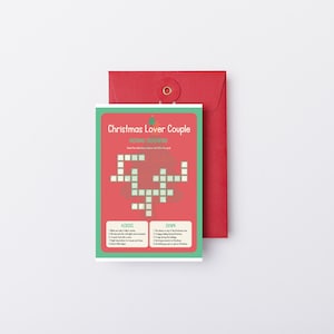 May include: A rectangular Christmas crossword puzzle card with a red and green border, featuring the text Christmas Lover Couple and a grid of empty white squares. The card is positioned in front of a solid red envelope with a circular clasp.