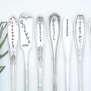May include: Set of eight silver spoons with engraved names of herbs: Rosemary, Chives, Parsley, Basil, Cilantro, Thyme, and Sage.