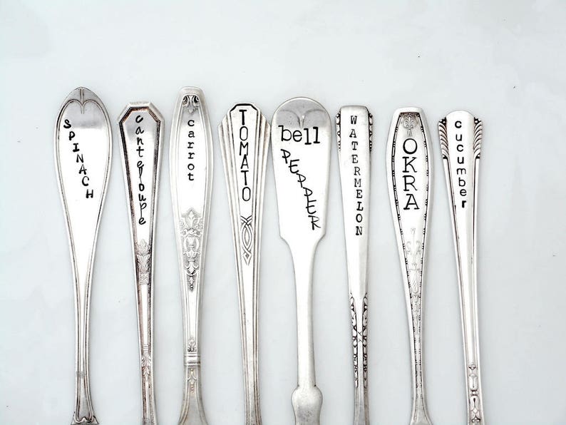 May include: Nine silver spoons with engraved names of vegetables, including spinach, carrot, tomato, bell pepper, watermelon, okra, and cucumber.