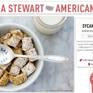 May include: A white bowl filled with cereal and a silver spoon with the words "Cereal Killer" stamped on it. The spoon is resting on the edge of the bowl. The image is a close-up of the bowl and spoon. The background is a white marble surface. The text "Sycamore Hill American Made Since 2010 2014 Crafts Finalist" is visible in the image.