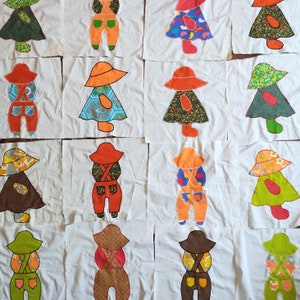 May include: A set of 12 colorful fabric appliques featuring children wearing overalls and dresses. The appliques are sewn onto white fabric squares and feature various patterns and colors.
