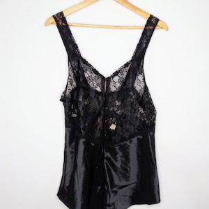 May include: Black lace and satin sleepwear with a V-neckline.