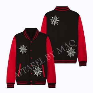 May include: Black and red baseball jacket with white spiderweb designs on the front and back.  The jacket has a zipper closure and a button-up front.