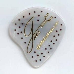 May include: A pearlescent guitar pick with a unique shape, featuring a gold-colored "G" and the text "HEX" and "giladhekseman.com". The pick is adorned with small, evenly spaced dark red dots, and a guitar headstock design.