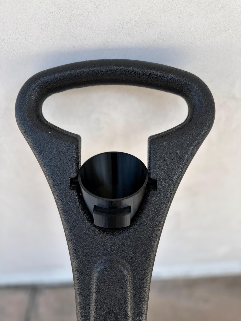May include: Black plastic handle with a black plastic funnel attached. The handle has a D-shaped opening.