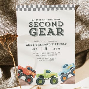 May include: A birthday party invitation with the text "ANDY IS SHIFTING INTO SECOND GEAR". The invitation features three colorful monster truck illustrations. The date is February 5th at 2 PM. The invitation is on a white background.
