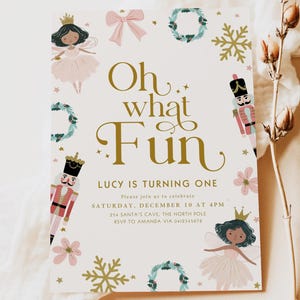May include: A party invitation with the text "Oh what Fun" in gold script, decorated with illustrations of fairies, nutcrackers, snowflakes, and wreaths. The invitation is for Lucy's first birthday.