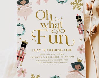 May include: A party invitation with the text "Oh what Fun" in gold script, decorated with illustrations of fairies, nutcrackers, snowflakes, and wreaths. The invitation is for Lucy's first birthday.