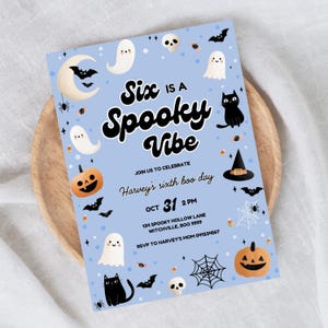 May include: A light blue Halloween party invitation with the text "Six is a Spooky Vibe." The invitation features illustrations of ghosts, bats, pumpkins, and a black cat. The date is October 31st.