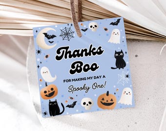 May include: A light blue Halloween-themed gift tag with the words "Thanks Boo" and "For making my day a Spooky One!". The tag features illustrations of ghosts, pumpkins, bats, spiders, and a black cat.