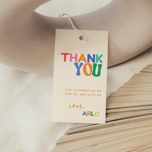 Retro kids birthday thank you tag with rainbow tones and playful confetti styling.
Colourful boy or girl birthday favor tag, bright fun Canva template printable.