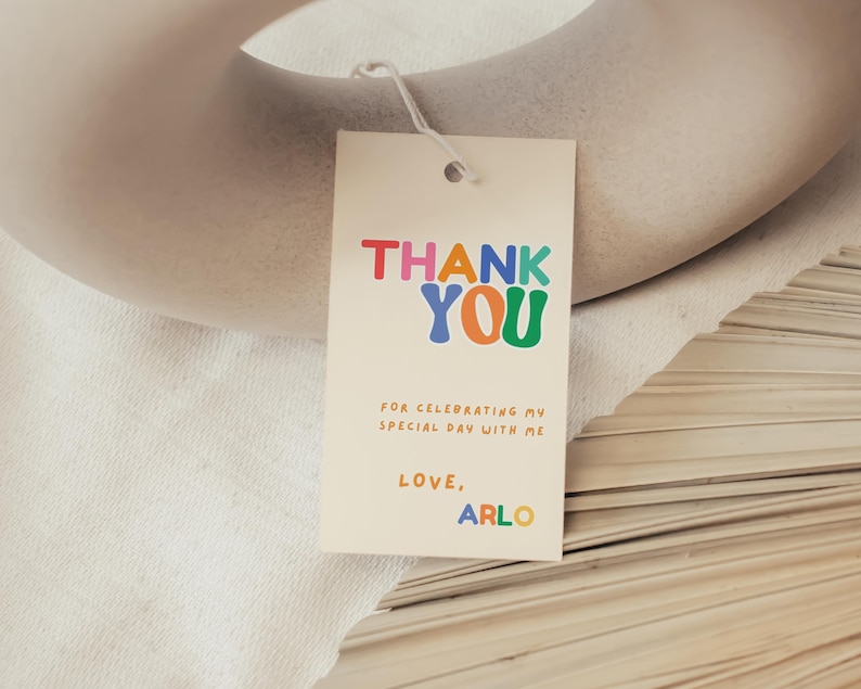 Retro kids birthday thank you tag with rainbow tones and playful confetti styling.
Colourful boy or girl birthday favor tag, bright fun Canva template printable.