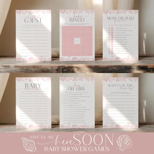 May include: A collection of six baby shower game cards with a seashell theme. The cards include games like "Guest," "Baby Bingo," and "Mom or Dad Guess Who." The text "She'll be here soon" is also displayed. The cards are white with pink accents.