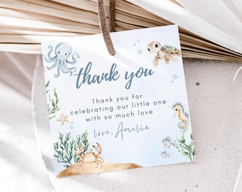 May include: A square thank you tag with a brown string. The tag features watercolor illustrations of sea creatures, including an octopus, turtle, crab, and seahorse. The text reads "thank you" and a personalized message.