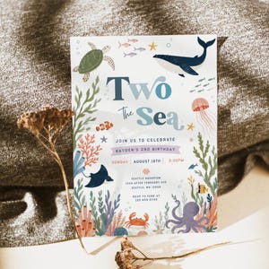 May include: A rectangular birthday invitation card featuring an underwater theme with illustrations of a sea turtle, whale, jellyfish, octopus, crab, and various fish. The text reads Two The Sea, Join Us To Celebrate Kayden's 2nd Birthday, Sunday August 18th, 2:30PM, Seattle Aquarium, 1234 After February Ave, Seattle, WA 12569, RSVP To Febe At 125 659 8745.