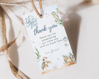 May include: A white gift tag with a watercolor ocean theme. The tag features an octopus, seahorse, turtle, and crab. Text reads "thank you" and "Thank you for celebrating our little one with so much love, love, Amelia."