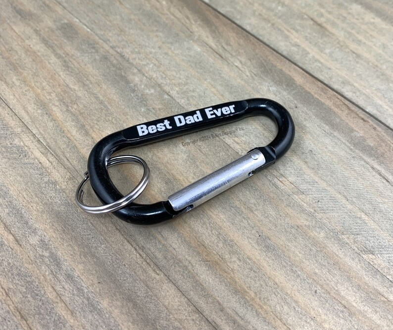 May include: Black carabiner keychain with a silver ring and the text "Best Dad Ever" printed in white.