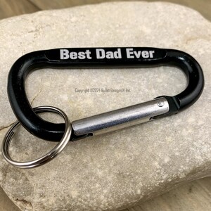 May include: Black carabiner keychain with a silver ring and the text "Best Dad Ever" engraved on the top.