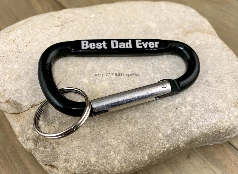 May include: Black carabiner keychain with a silver ring and the text "Best Dad Ever" engraved on the top.