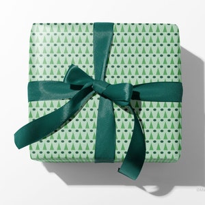 Christmas gift wrapped with green, modern geometric wrapping paper by Marisa Dolan