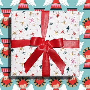 Christmas gift wrapped in mid-century modern, Christmas stars wrapping paper with a red ribbon designed by Marisa Dolan