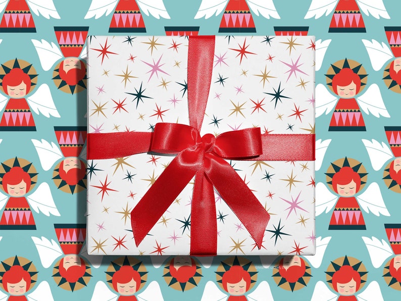 Christmas gift wrapped in mid-century modern, Christmas stars wrapping paper with a red ribbon designed by Marisa Dolan