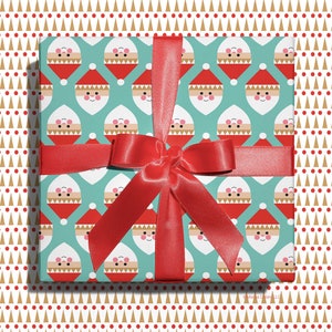 Christmas gift wrapped in modern, geometric Santa wrapping paper with red ribbon