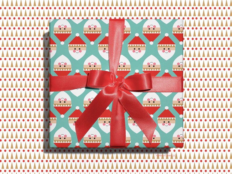 Christmas gift wrapped in modern, geometric Santa wrapping paper with red ribbon