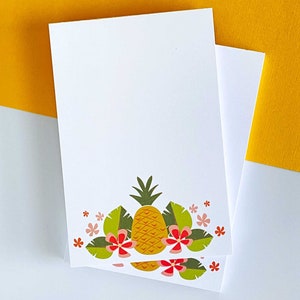 May include: Two white note cards with a pineapple and tropical flower design printed on the bottom edge. The pineapple is yellow with green leaves and the flowers are pink and red.
