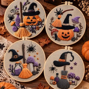 May include: Four circular embroidery hoops featuring Halloween-themed designs on beige fabric. Each hoop displays a combination of embroidered pumpkins, witch hats, brooms, spiders, purple mushrooms, and glass bottles with purple liquid.
