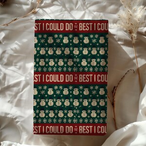 May include: A rectangular, Christmas-themed item with a green background and a repeating pattern of snowmen and snowflakes. The top and bottom feature a red band with the text "ST I COULD DO BEST I COU".