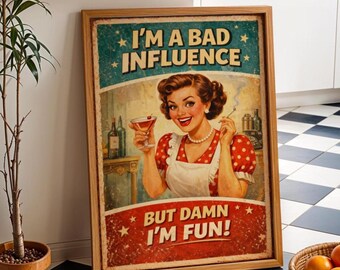 Peut inclure: Une affiche encadrée de style vintage représentant une personne souriante en robe rouge à pois et tablier blanc, tenant un cocktail et une cigarette. Le texte indique I'M A BAD INFLUENCE en haut et BUT DAMN I'M FUN! en bas en lettres grasses.