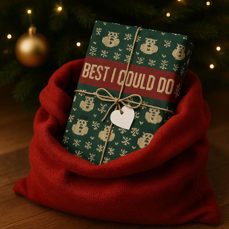 May include: A wrapped gift with a green and beige pattern, tied with twine and a heart-shaped tag, rests in a red sack. The gift wrap features the text "BEST I COULD DO" in a red band.