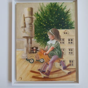 May include: An oil painting in a white frame depicting a child with brown hair wearing a green dress and purple leggings, riding a wooden rocking horse. In the background, a large nutcracker, a dollhouse, and a Christmas tree with lights.