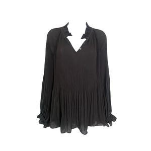 May include: A black long-sleeved blouse featuring a V-neckline with a small collar, a button-down front placket, and vertical pleats throughout the bodice. The sleeves are loose and flowy, ending in ruffled cuffs with a gathered hemline.
