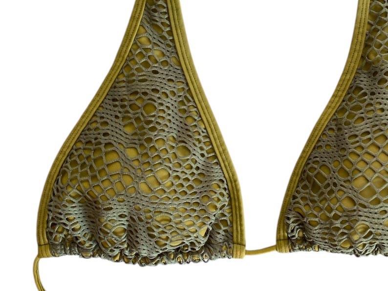 May include: A green bikini top with a mesh and snakeskin pattern.