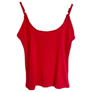 May include: A bright red sleeveless tank top with a scoop neck.
