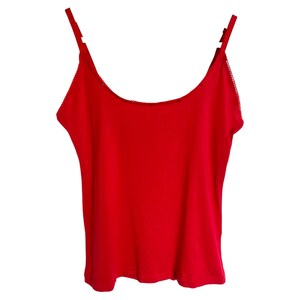 May include: A bright red sleeveless tank top with thin straps.