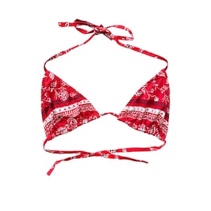 May include: Red and white patterned bikini top with adjustable straps.