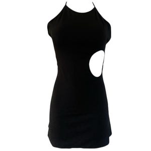 May include: A black halter dress with a cutout detail on the side. The dress is sleeveless and has a fitted silhouette. The cutout is a large, oval shape. The dress is made of a smooth, solid fabric.