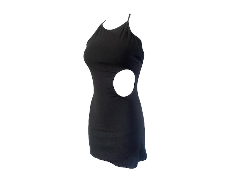 May include: A black mini dress with a halter neckline and a side cutout. The dress is sleeveless and form-fitting, showcasing a sleek and modern design. The dress is made of a soft, stretchy material.