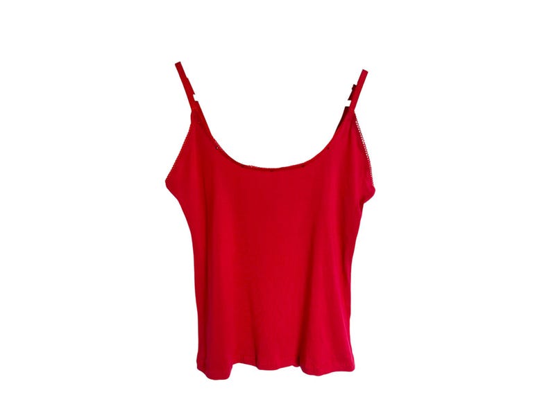 May include: A red sleeveless tank top with thin straps.